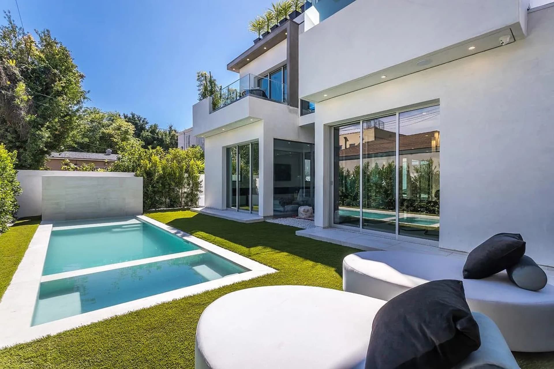 Formosa Residence — corner sliding glass walls fully open to the pool terrace
