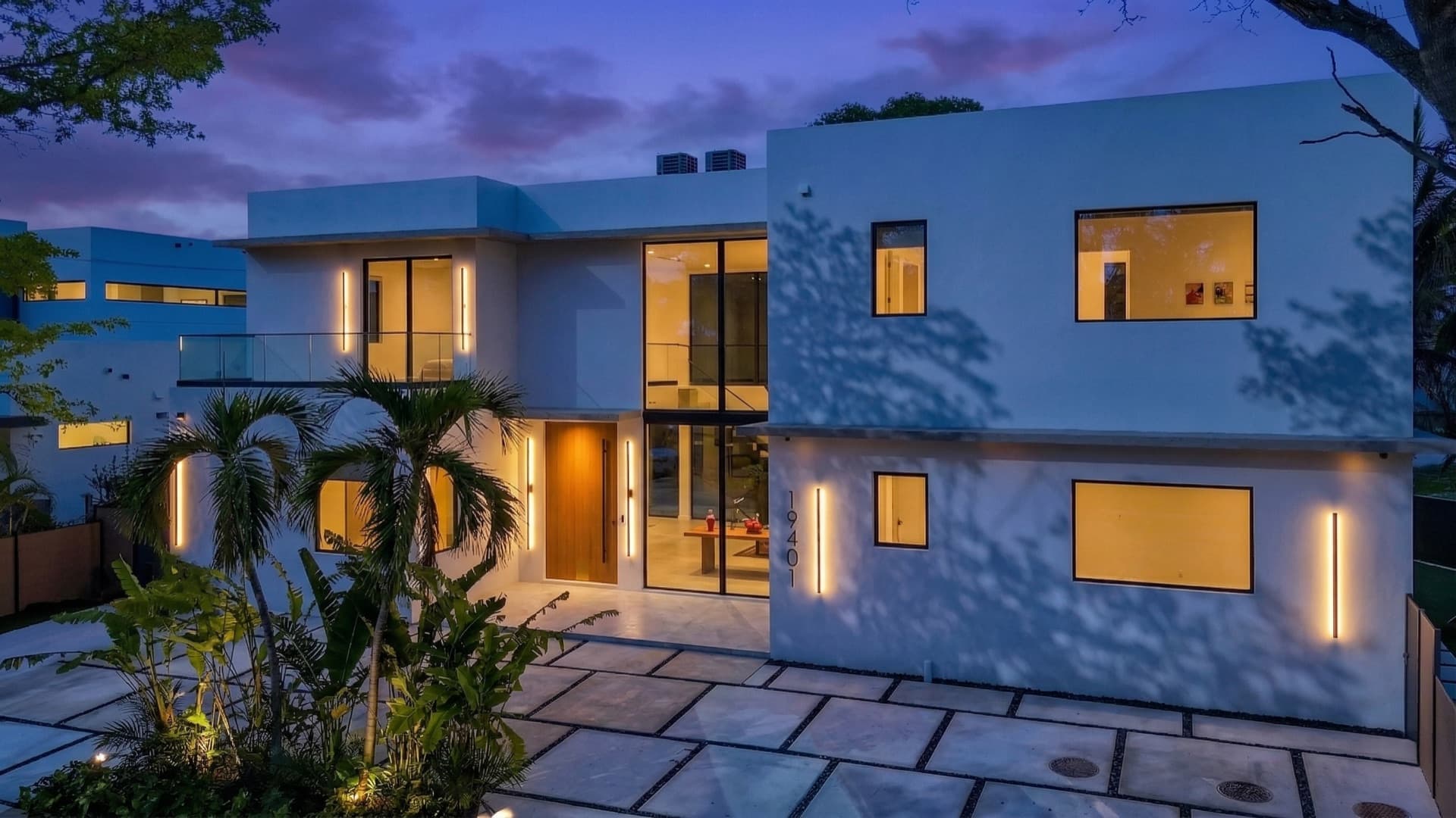 Dusk exterior with illuminated full-height glazing