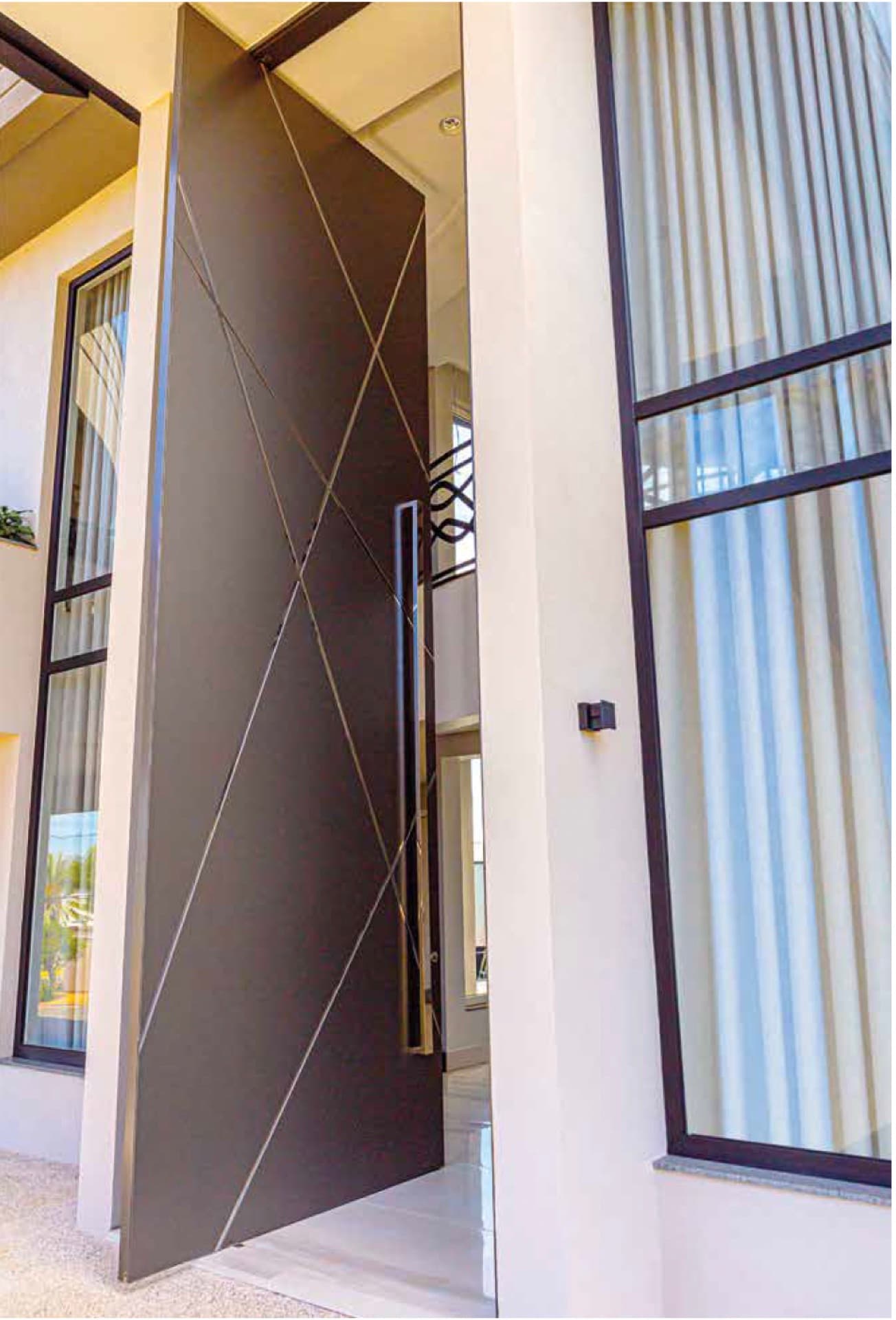 System 115 pivot door — open leaf edge with interior beyond