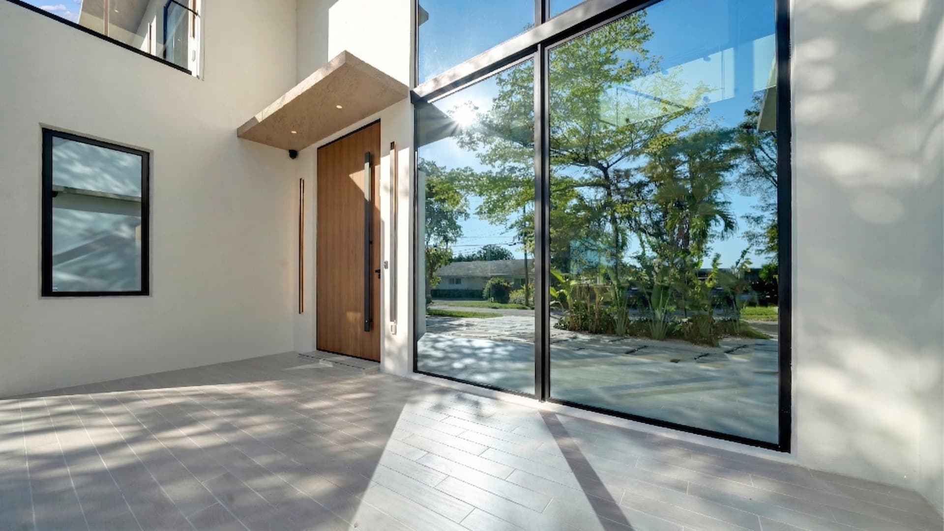 Full-height sliding glass doors at the covered terrace — North Miami Beach Residence