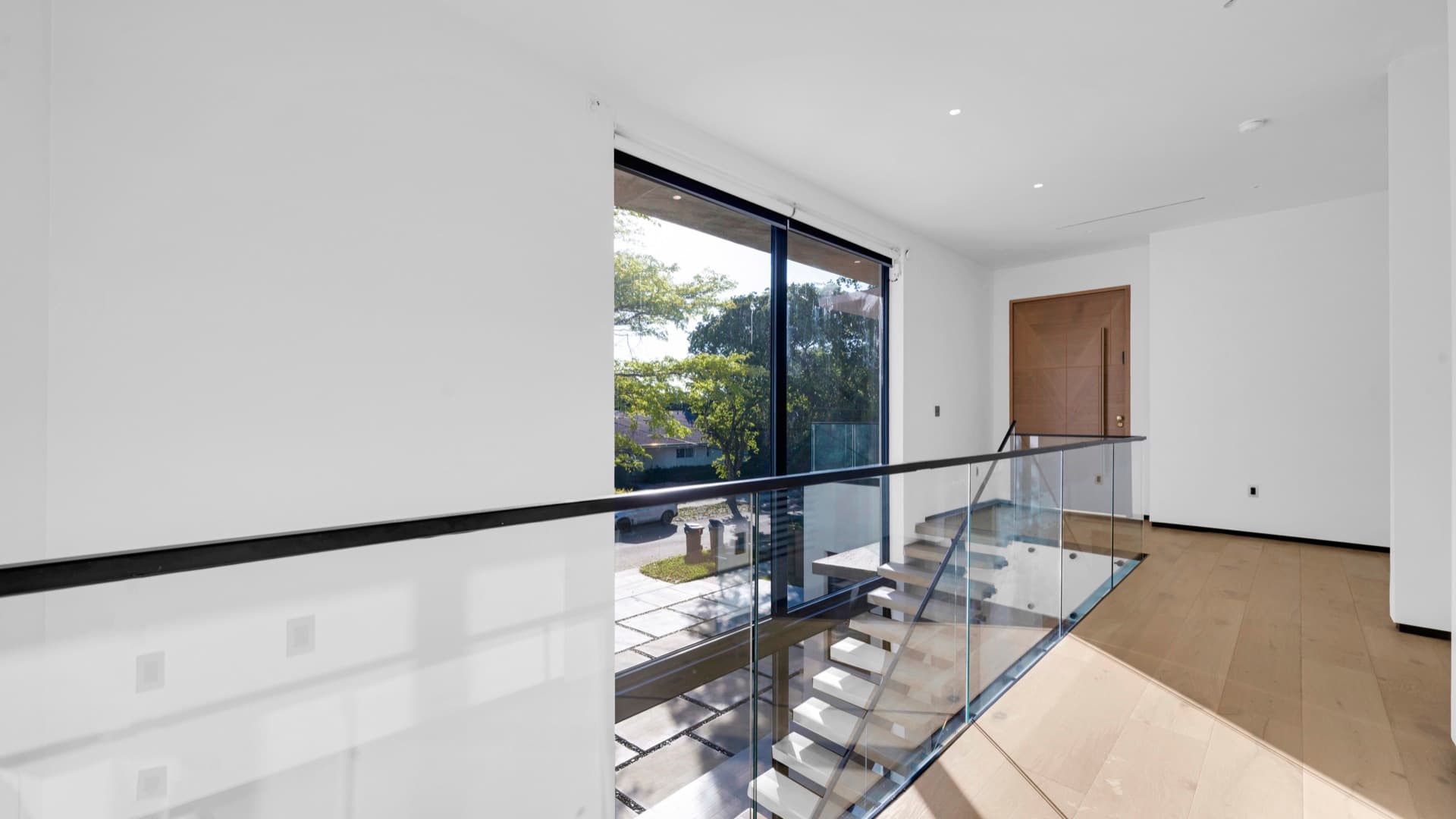 Glass railing at the upstairs landing of the North Miami Beach residence